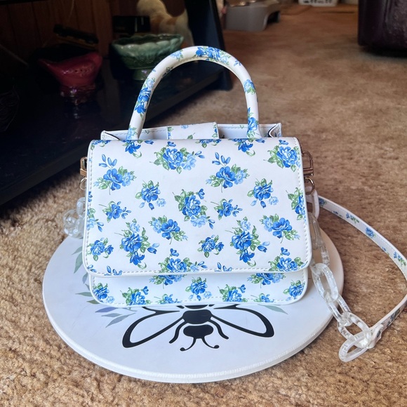 HOUSE OF WANT Handbags - HOUSE OF WANT WE ARE CHIC VEGAN LEATHER TOP HANDLE CROSSBODY IN BLUE FLORAL.
